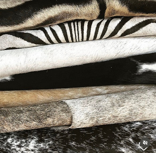 folded stack of various animal hides